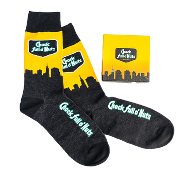 A pair of Chock full o’Nuts® Socks - New York Skyline rests neatly beside a box.